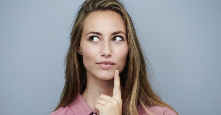 A lady looking to the upper left of the screen (from your perspective) and looking inquisitive with a finger on her chin. He sort of looks like shes thinking, "Hmmmm"
