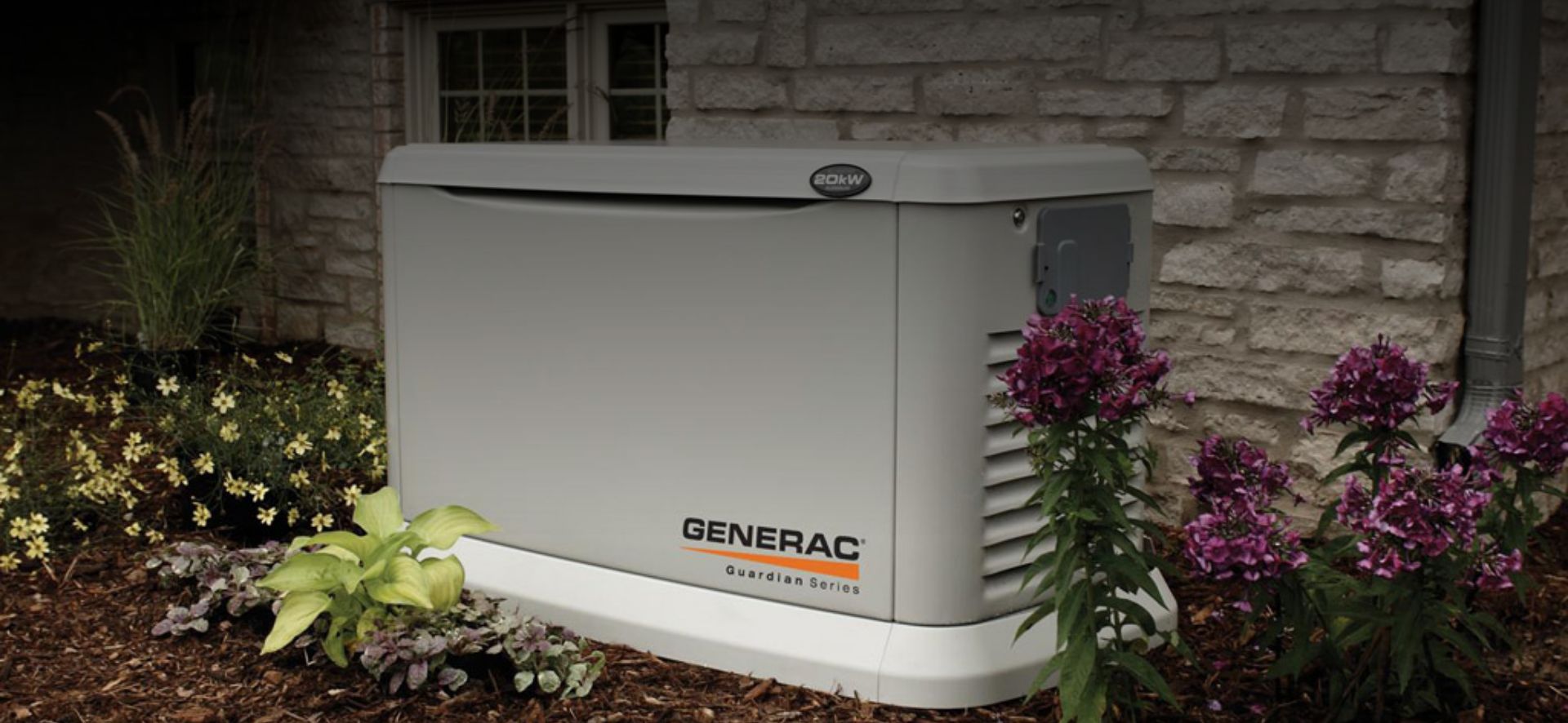 Generac_Generator_Residential Close up shot of a generator next to a brick house