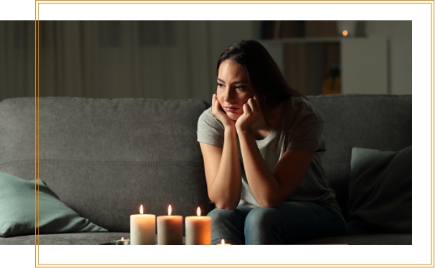 sad woman using candles without a home standby generator