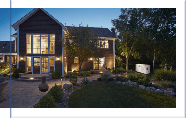 large house lit with generac home standby generator